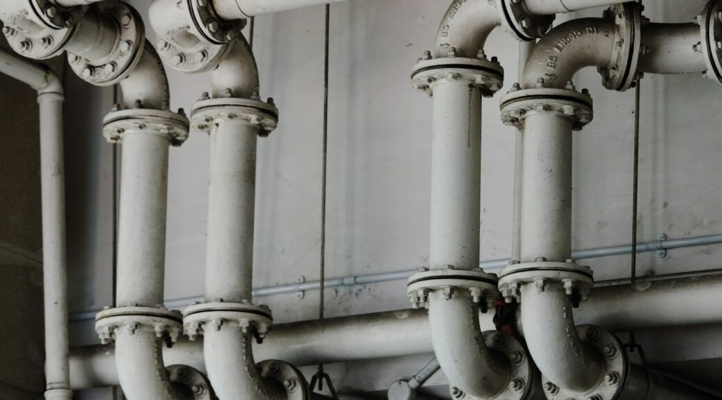grayscale photography of metal pipes